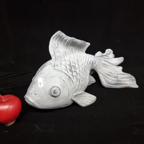 114 - A large and elegant Koi Carp sculptural piece. In a soft grey with detailed scales and fin detail. L... 