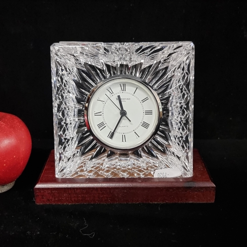 117 - A large Waterford Crystal desk clock with scalloped detail on a wooden base in good condition.