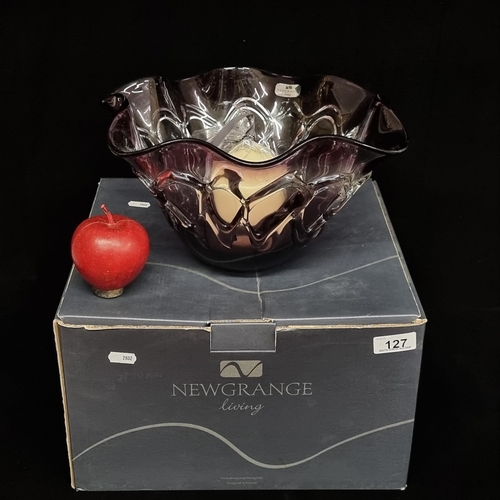 127 - A large, handblown amethyst glass display bowl by Newgrange Living. With a sealed pillar candle. In ... 