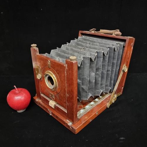 192 - A mid-Victorian bellows camera with mahogany frame, leather bellows and space for glass plate to rev... 