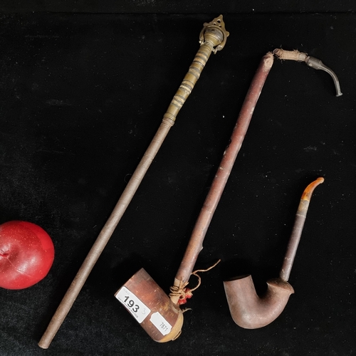 193 - Three items including two wooden pipes, one with an amber toned mouthpiece the other with a sprung m... 