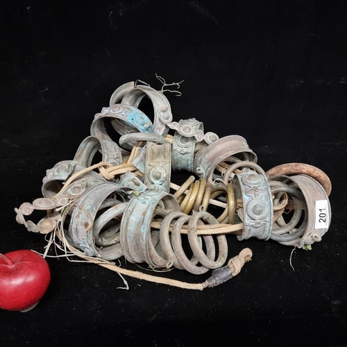 201 - A large number of 19th century brass circlets held together on a rope. Interesting lot very decorati... 