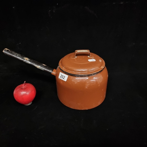 202 - A vintage enamelled metal 'Judge Brand' saucepan with lid with 4 pint capacity.