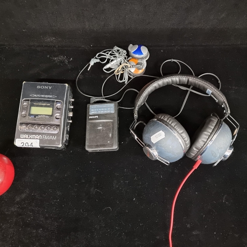 204 - A mixed lot of 5 items including 3 sets of earphones one by Canon reading H. Schiffmacher along with... 