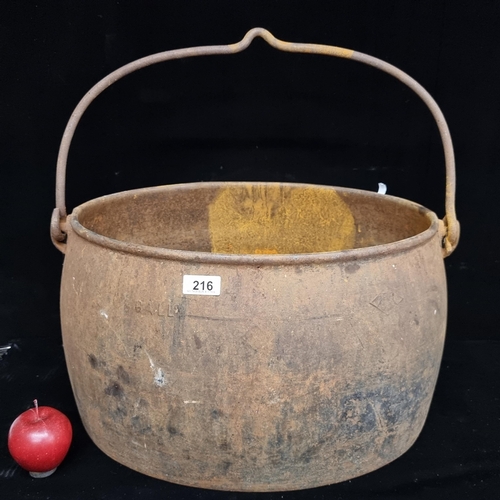 216 - A very large heavy cast metal cauldron with handle. Perfect as a garden planter or for Halloween.