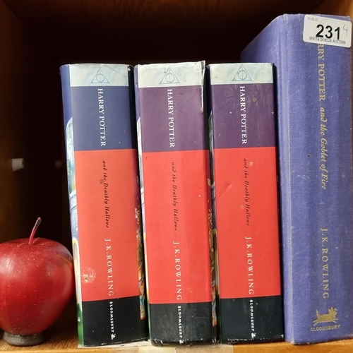 231 - Four hardback copies of first edition Harry Potter books, including three copies of 