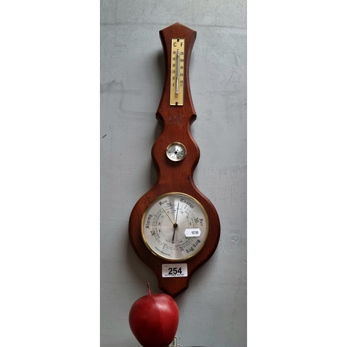 254 - A Weathermaster barometer and thermometer, housed in a wooden frame with convex face.