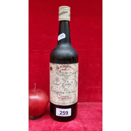 259 - A sealed vintage early bottle of Rutherford & Miles extra pale madeira wine.