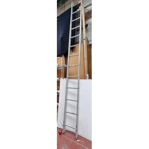 293 - A very tall, high quality thirteen-rung aluminium ladder.