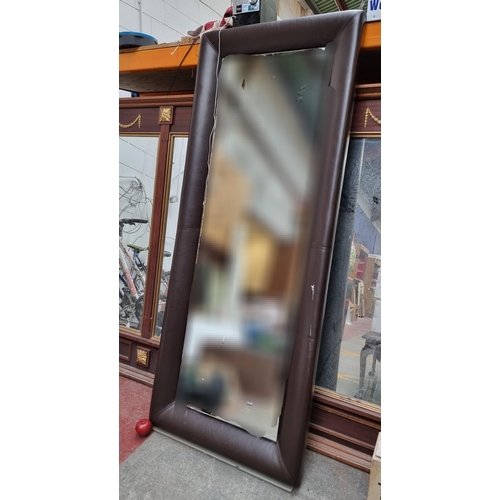 302 - A marvellous, very large ultra modern full length mirror set into a brown leather padded frame. Meas... 