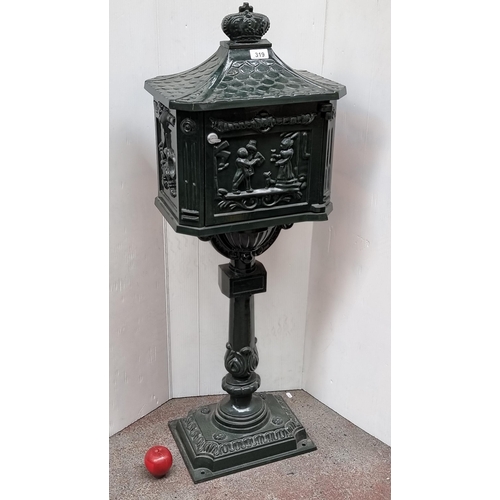 319 - A charming large metal post box, with a crown top and domestic English scenes. In a forest green ena... 