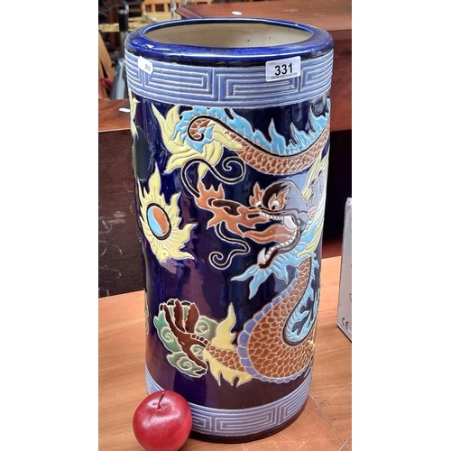 331 - A large  Chinese inspired umbrella stand with a rich cobalt blue glaze and a large sinuous dragon fi... 