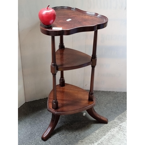 339 - A small antique-style, three-tier plant stand with turned legs and splayed feet.