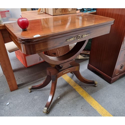 342 - Star Lot : A lovely antique-style folding table with lion paw feet and casters, brass toned hardware... 