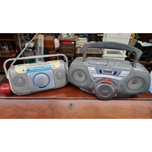 356 - A pair of portable CD / radio players, including a Sony CFD-G50L with a Sony CD radio cassette-corde... 