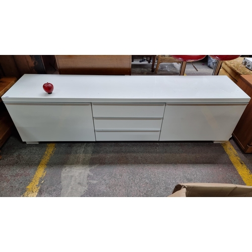 380 - Star Lot : A contemporary, sleek Bestaburs TV unit, with chrome handles and five compartments, inclu... 