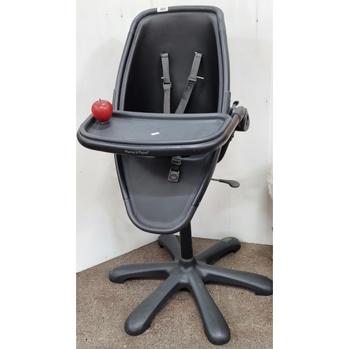 384 - An adjustable Mamas & Papas Loop high feeding chair, in a shade of black. With security straps.