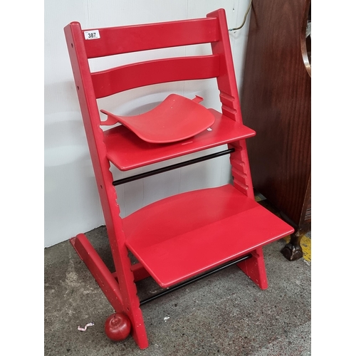 387 - A Stokke Tripp Trapp adjustable high chair, in a red finish. From The Huge Penthouse in Grand Canal ... 