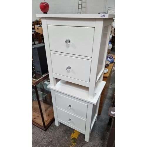 396 - Two good bedside cabinets with faceted crystal handles. Each with two deep drawers, in a shade of of... 