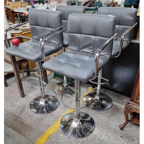 400 - A set of four breakfast bar stool with leather seats in a shade of charcoal grey, with chrome body. ... 