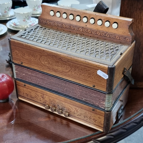 405 - A super antique example of a Hohner Accordian , with foliate carved details. Nice looking piece.