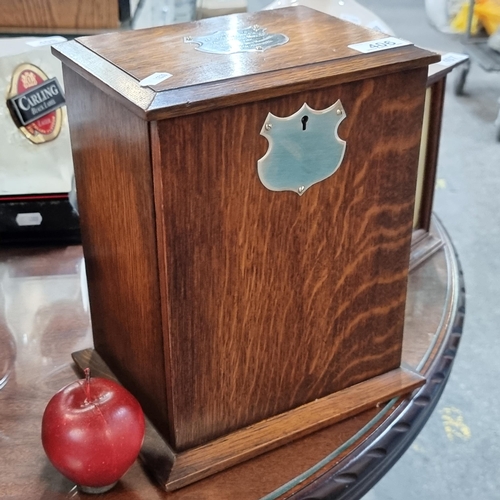 406 - An early twentieth century oak smoker's compendium, with a sterling silver plaque saying 