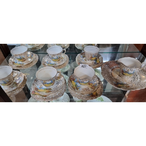 427 - A twenty-six piece Colclough bone china tea service, featuring a woman in an outdoor scenery.