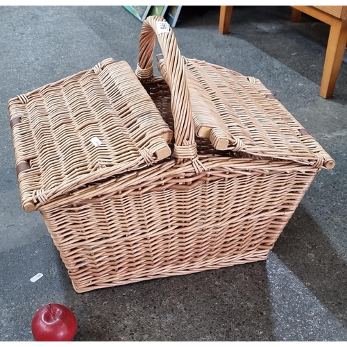 646 - A two-door wicker basket by Fortnum & Mason, with a selection of interesting key chains.