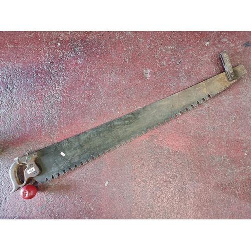 664 - A brilliant example of a very large early twentieth century two handled cross-cut saw. Lovely age to... 