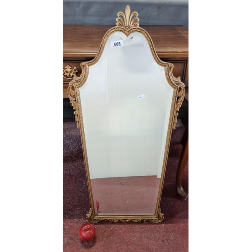 665 - A vintage Peerart bevelled mirror in an ornate gilt frame with fleur de lis details. H91cm x W43cm R... 