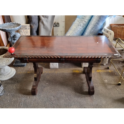 671 - An elegant Victorian console table with carved border, two drawers to the front, and a stretcher bet... 