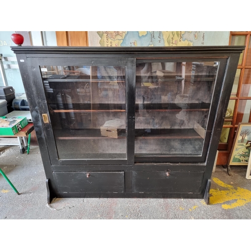 677 - Star lot : A stunning antique Edwardian shop display cabinet with sliding doors and two bottom stora... 