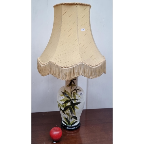 694 - A nice example of a ceramic lamp with bamboo leaf features and a ribbed design. Topped with a light ... 