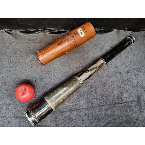 724 - A wonderful early twentieth century three-draw night and day telescope. With a tooled leather grip a... 