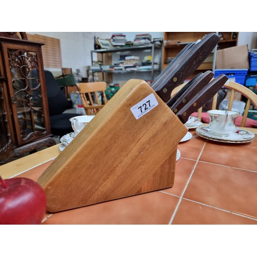 727 - A  solid knife block with six knives, including five Regent knives and one Kitchen Devil bread knife... 