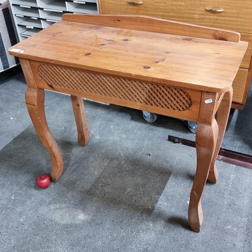 772 - A neat pine wood console table with sabre legs and a pierced trellis panel. Featuring a neat gallery... 