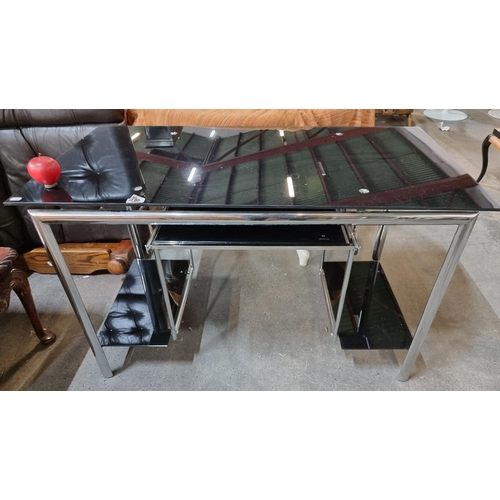 780 - Chrome framed black glass desk with pull out keyboard tray. 24 x 47 inches In good order.