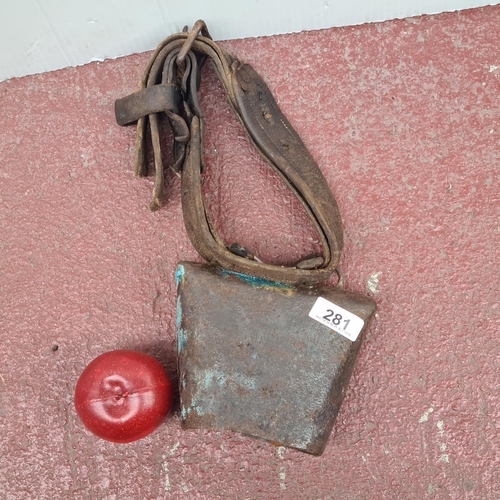 281 - An antique cowbell with original leather strap. Wonderful age and patina to this piece.