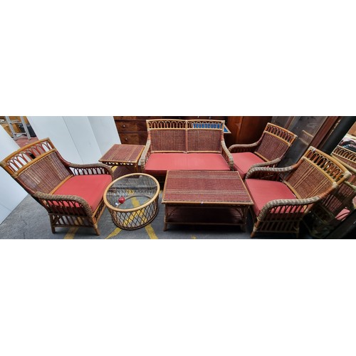 218 - A marvellous seven-piece wicker lounge suite. Comprising of three armchairs, a two-seater sofa, and ... 