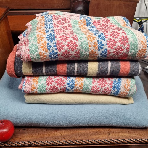 233 - A selection of five Irish wool blankets, including two in pretty pastel blues and creams, and anothe... 