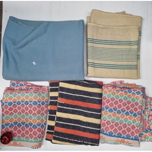 233 - A selection of five Irish wool blankets, including two in pretty pastel blues and creams, and anothe... 