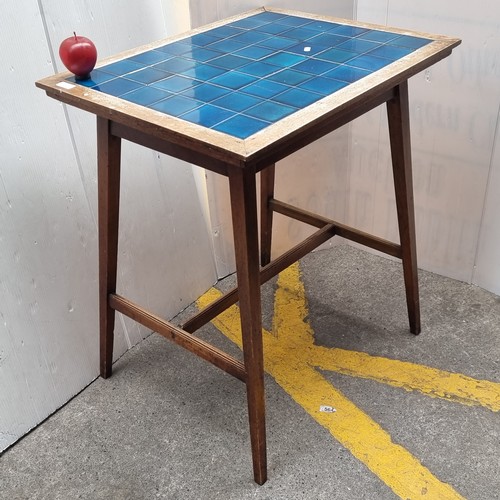 250 - An unusual early twentieth century occasional table inlaid with a quantity of ceramic tiles in a ric... 