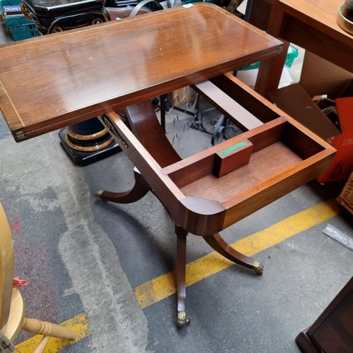 342 - Star Lot : A lovely antique-style folding table with lion paw feet and casters, brass toned hardware... 