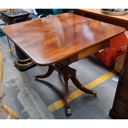 342 - Star Lot : A lovely antique-style folding table with lion paw feet and casters, brass toned hardware... 