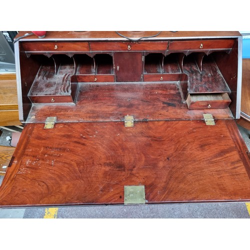 360 - A handsome example of a mahogany late Georgian writing Bureau with numerous neat-sized drawers inclu... 