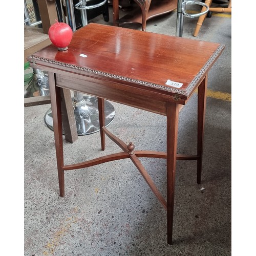 370 - Star Lot: A fabulous example of an Edwardian mahogany games table. With a folding top lined with red... 