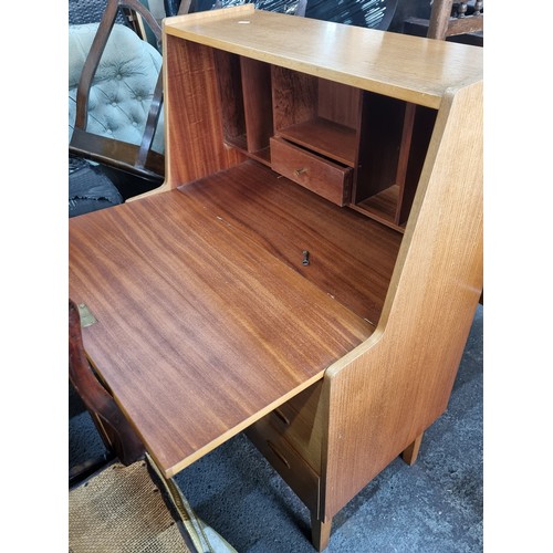 644 - A wonderful mid-century modern blonde teak writing bureau. The drop down slope opens to reveal a myr... 