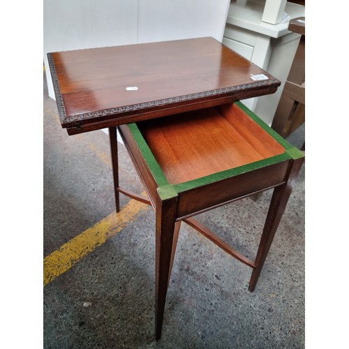 370 - Star Lot: A fabulous example of an Edwardian mahogany games table. With a folding top lined with red... 