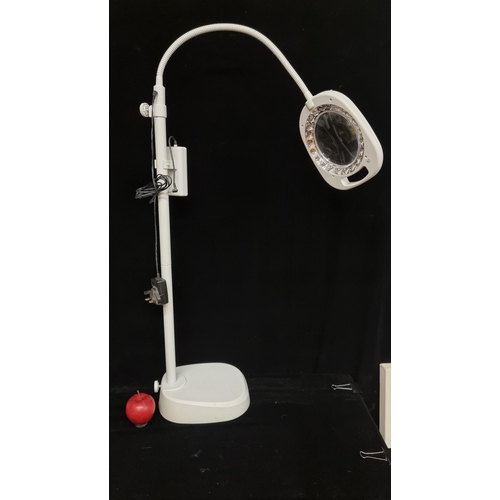 124 - A floor standing magnifying LED lamp in white.