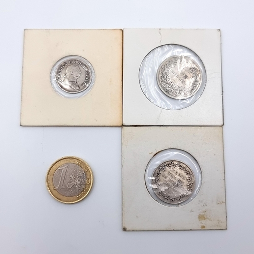 18 - Three Irish silver coins, consisting of an 1834 one shilling and two Dublin Bank Tokens.